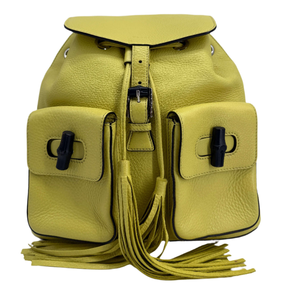 Gucci Medium Bamboo Backpack in Mimosa Flower, crafted in soft calfskin leather with decorative fringes and structured pockets.