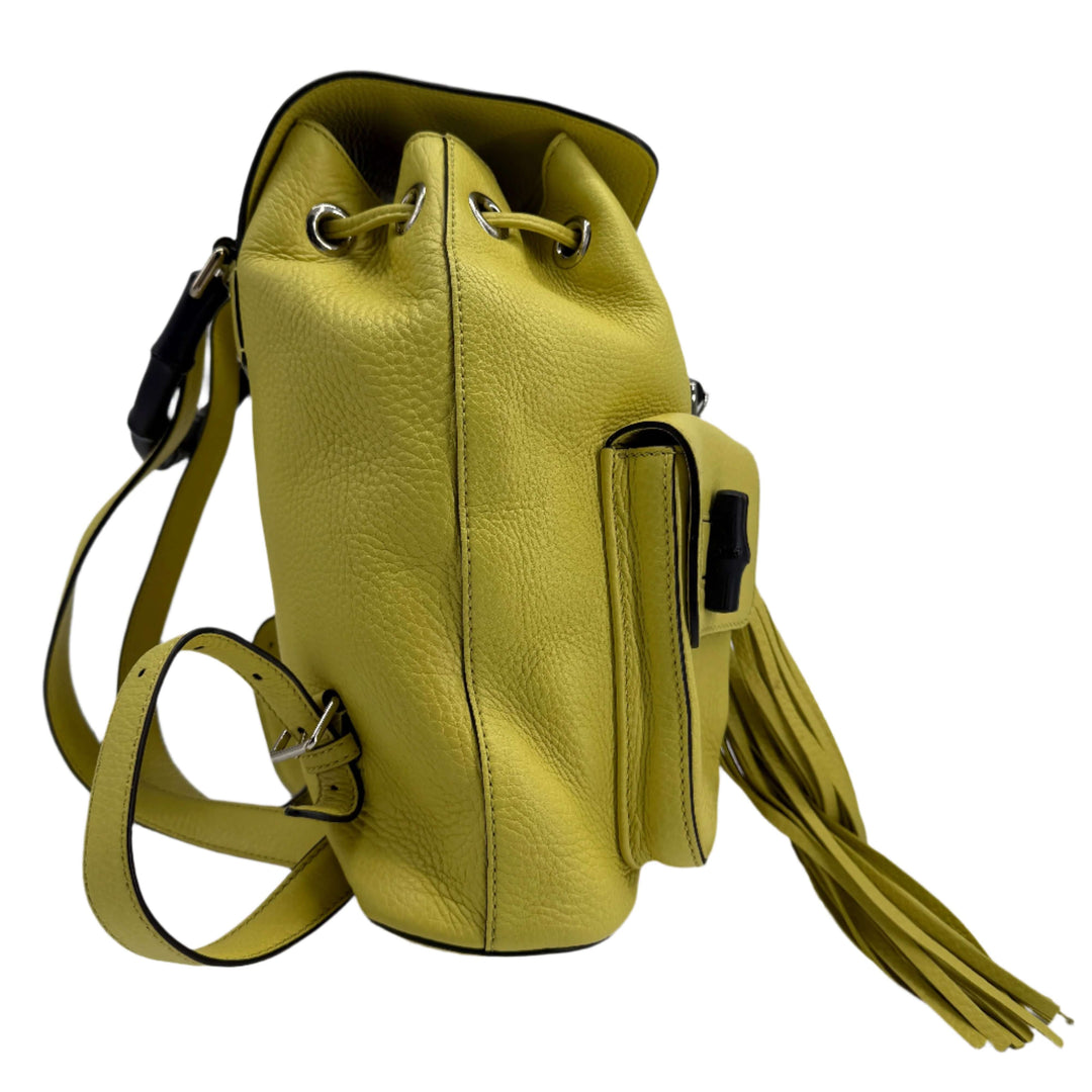 Gucci Cellarius Medium Bamboo Backpack in vibrant mimosa yellow leather with fringe detail and adjustable straps.