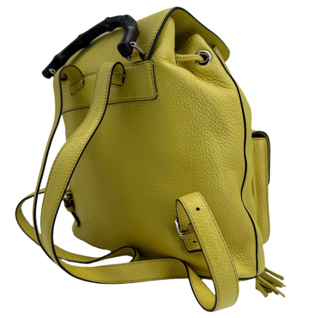 Gucci Cellarius Medium Bamboo Backpack in vibrant mimosa yellow calfskin leather, showcasing structured design and bamboo handle.