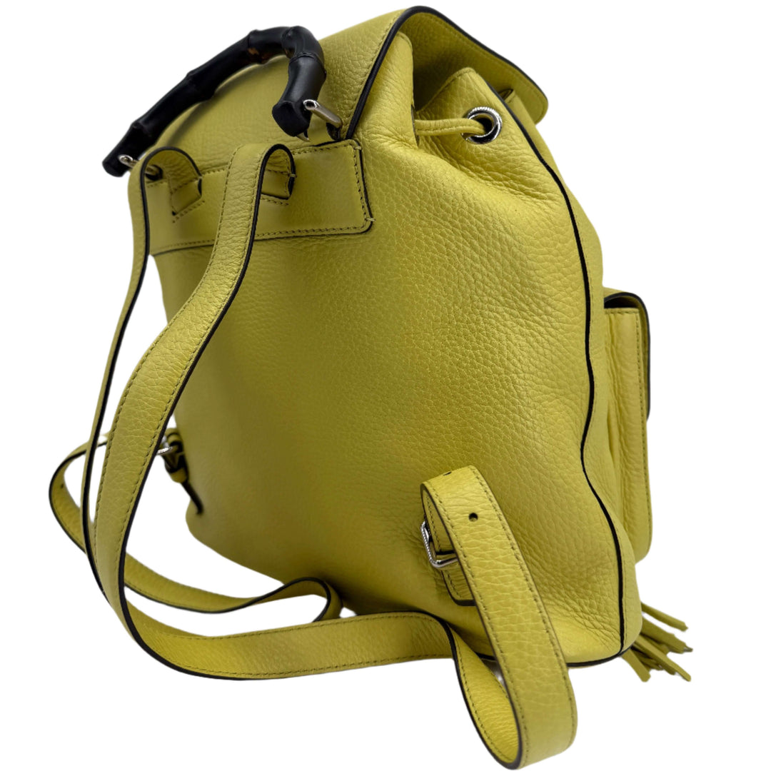 Gucci Cellarius Calfskin Medium Bamboo Backpack in vibrant mimosa yellow, showcasing bamboo handle and structured design.