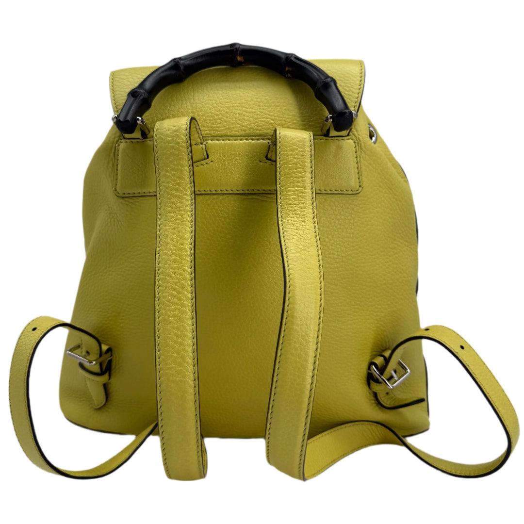 Gucci Medium Bamboo Backpack in vibrant mimosa yellow with structured bamboo handle and adjustable straps.