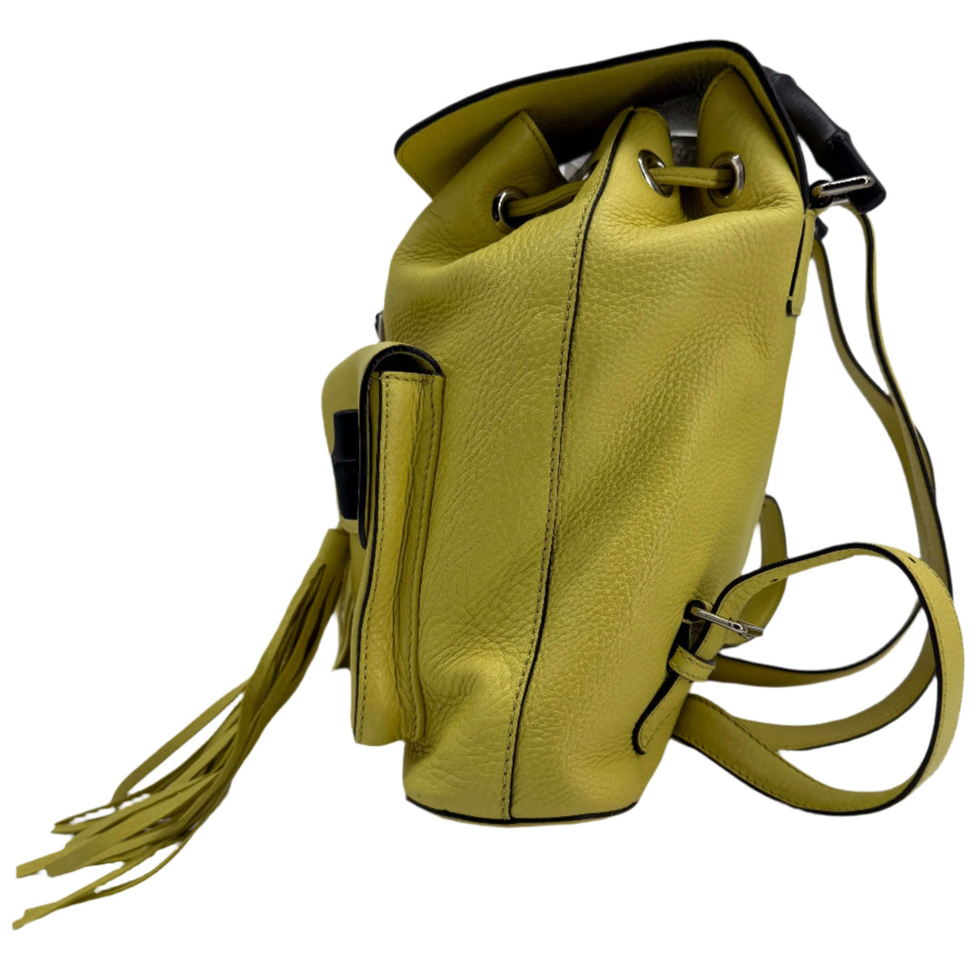 Gucci Cellarius Medium Bamboo Backpack in vibrant mimosa yellow leather with structured design and tassel accents.
