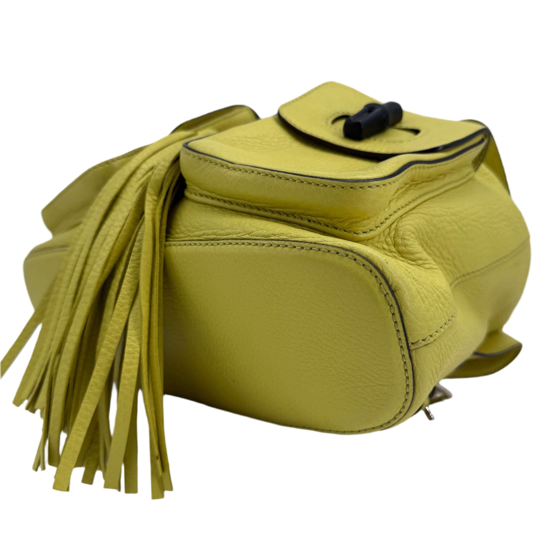 Gucci Cellarius Medium Bamboo Backpack in vibrant mimosa yellow leather with fringe detailing.