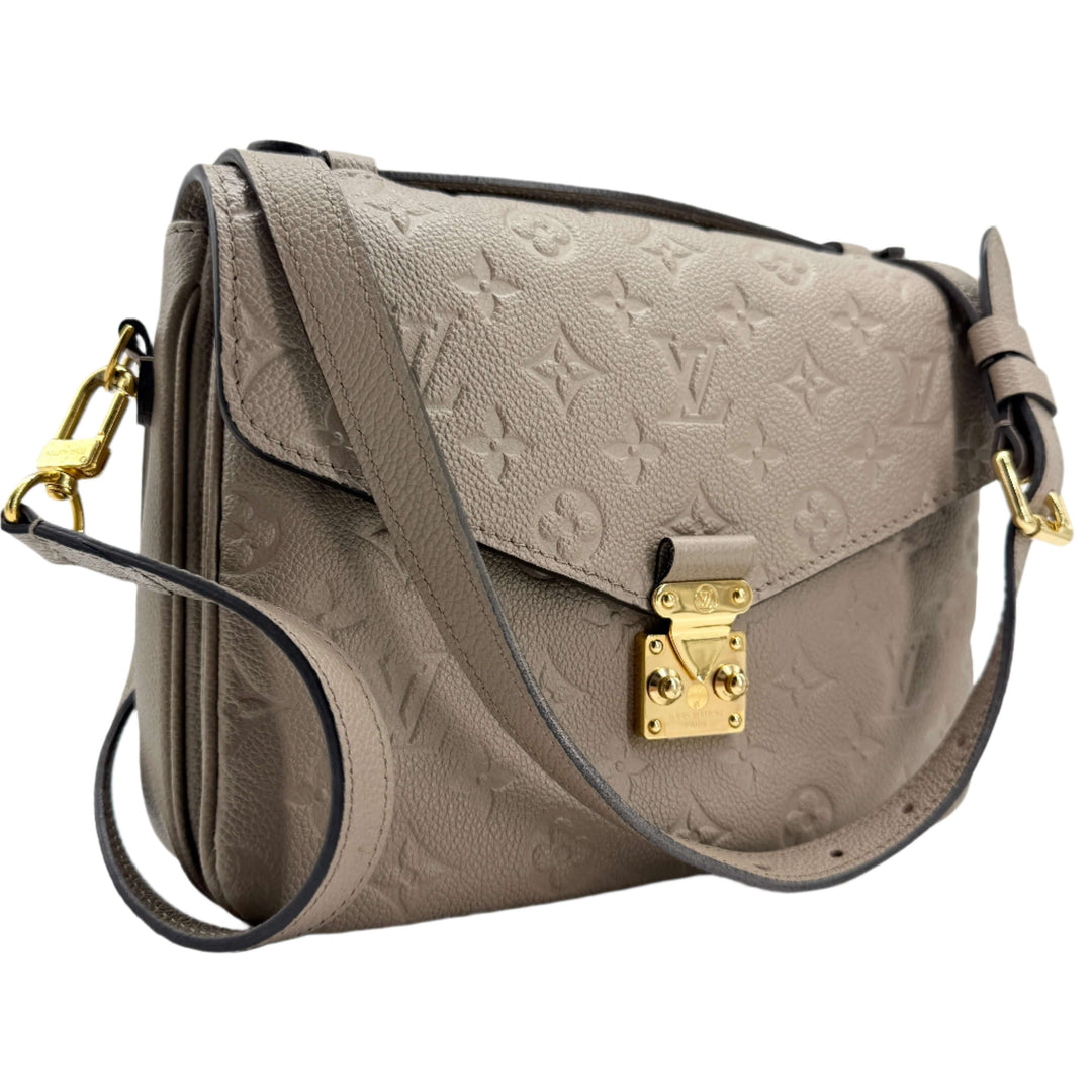 Louis Vuitton Pochette Métis in Tourterelle Grey Monogram Empreinte Leather with gold-tone hardware.