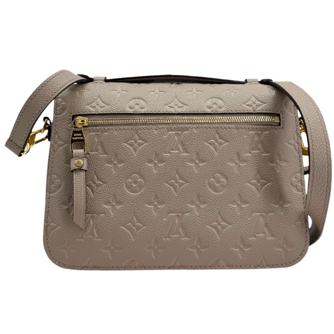 Louis Vuitton Pochette Métis in Tourterelle Grey, Monogram Empreinte leather with gold-tone zipper.
