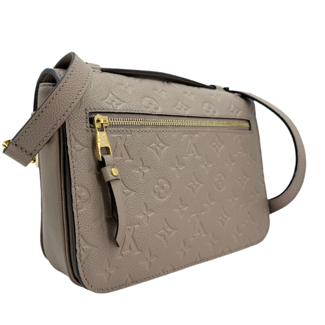 Louis Vuitton Pochette Métis in Monogram Empreinte leather, Tourterelle grey with gold-tone accents.