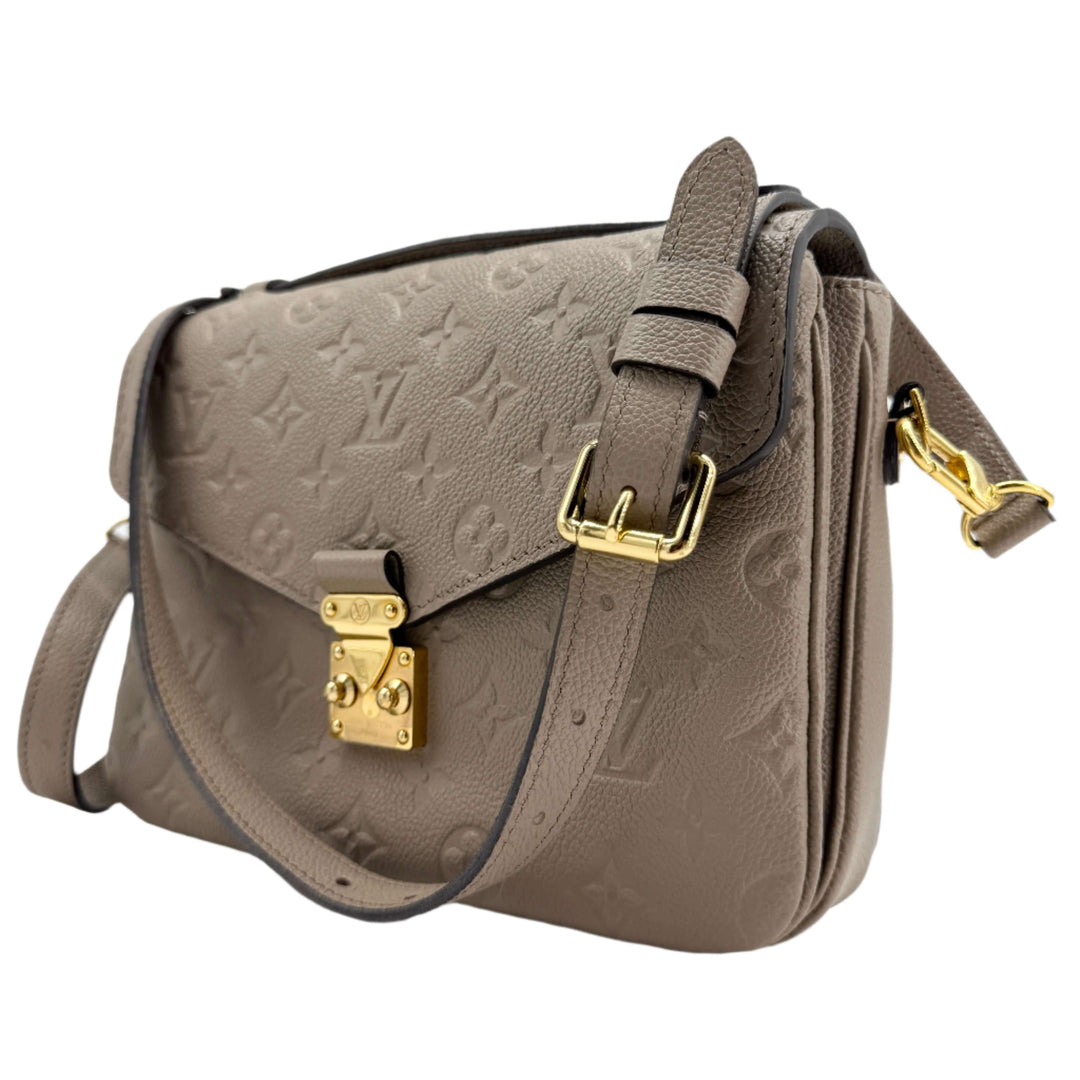 Louis Vuitton Pochette Métis in Tourterelle Grey, crafted from Monogram Empreinte leather with gold-tone hardware.