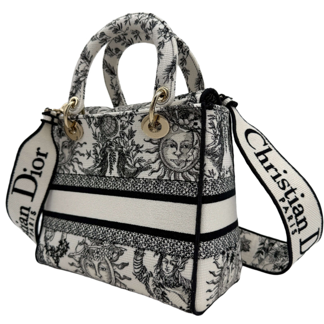Christian Dior Lady D-Lite Medium Bag in embroidered black and white canvas with iconic design and gold-tone hardware.