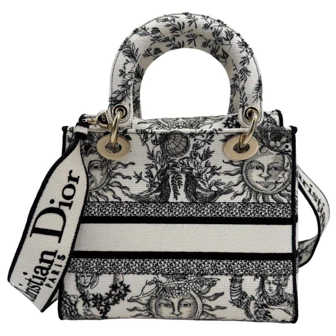 Christian Dior Lady D-Lite bag in embroidered canvas with sun motifs, black stripes, and statement strap.
