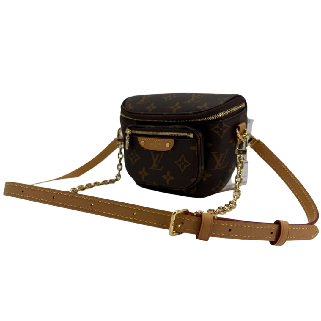 Louis Vuitton Mini Bumbag in Monogram Canvas with adjustable leather strap and removable chain, showcasing luxury and utility.