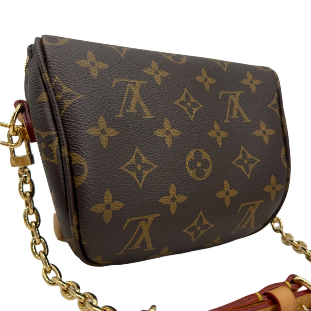 Louis Vuitton Mini Bumbag in Monogram Canvas with adjustable strap and removable chain detail.