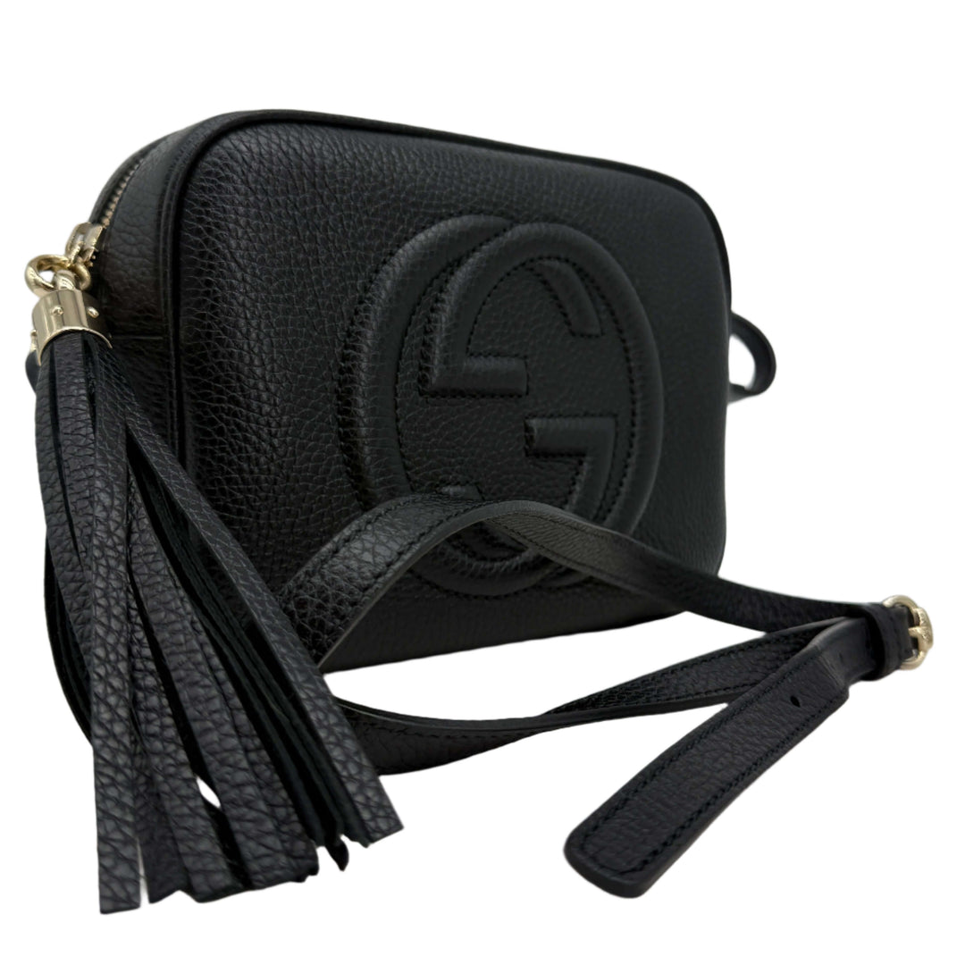 Gucci Small Soho Disco Bag in black pebbled calfskin leather with gold tassel and interlocking G logo.