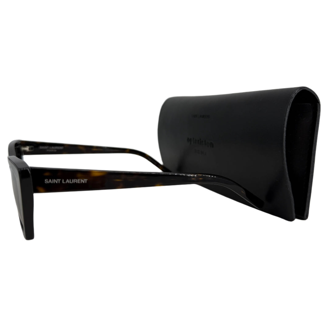 Saint Laurent cat eye frame sunglasses with tortoiseshell pattern, displayed beside a sleek black case.