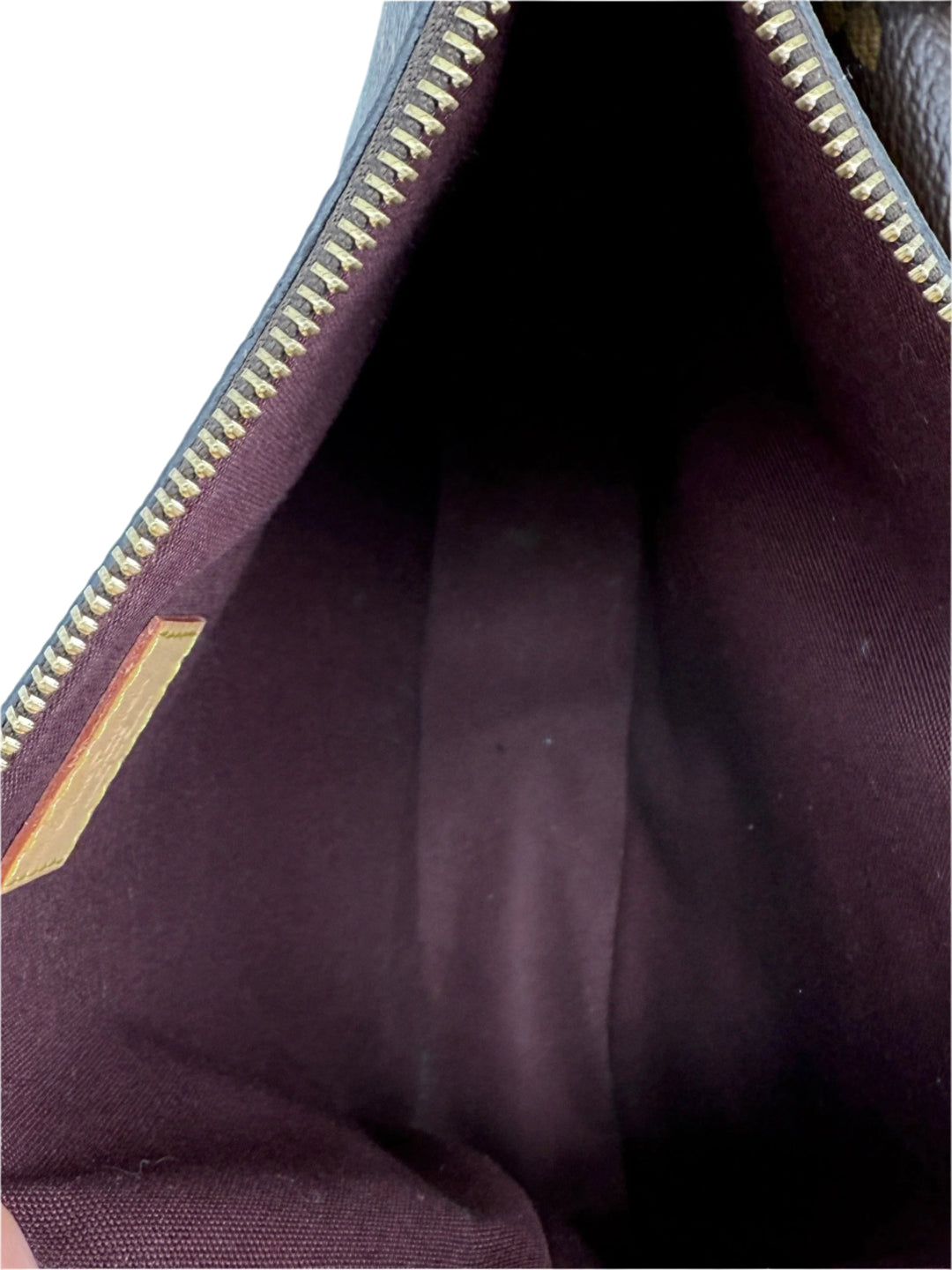 Interior view of Louis Vuitton Monogram Mabillon Shoulder Bag showcasing maroon lining and zip closure.