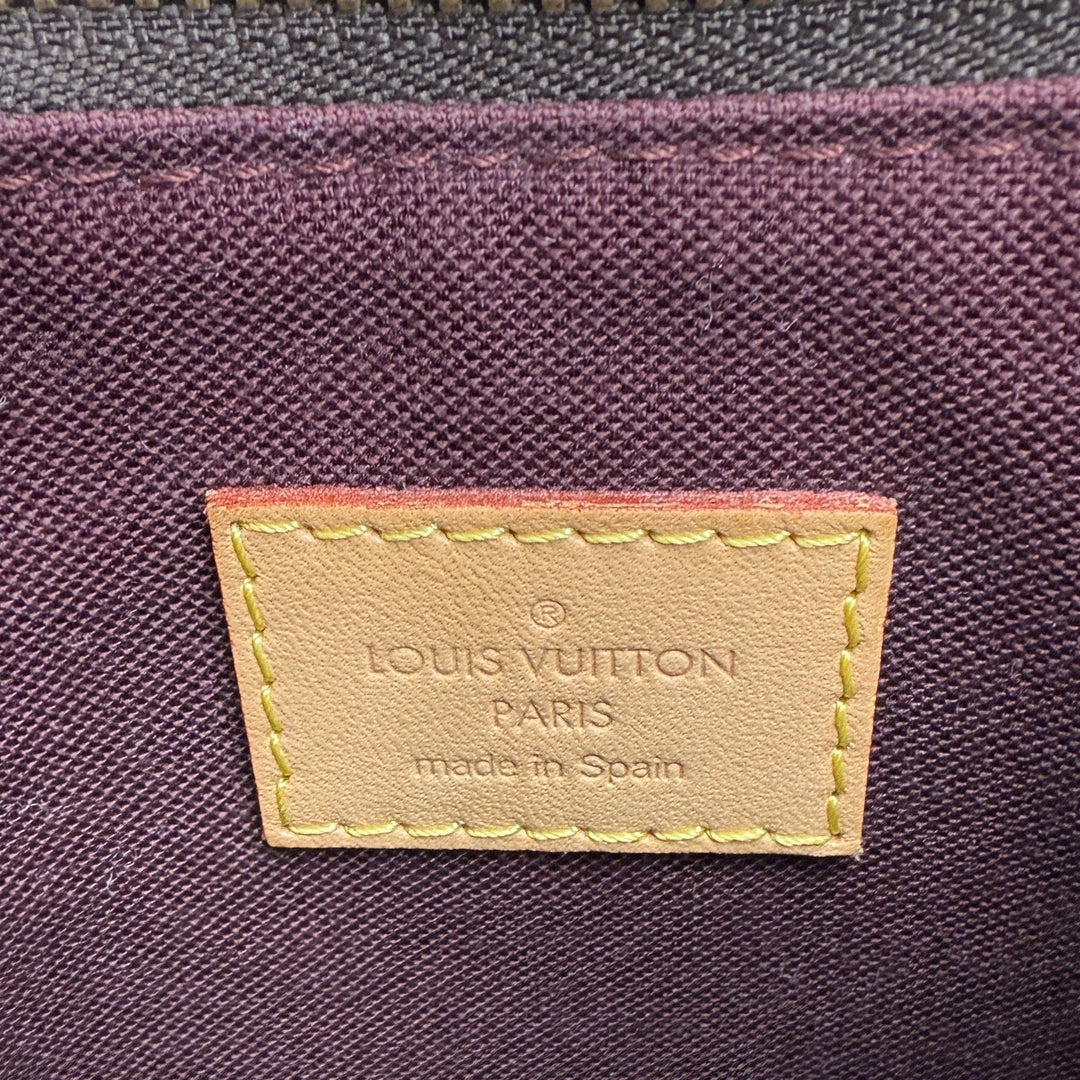 Louis Vuitton label showing Paris branding and 'made in Spain' on the interior of a handbag.