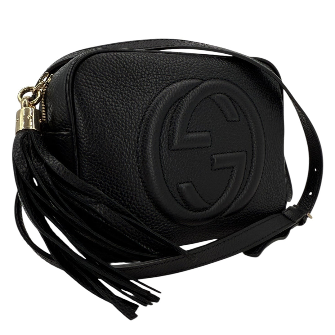 Gucci Soho Disco Small Crossbody in black pebbled calfskin with signature interlocking G and tassel.