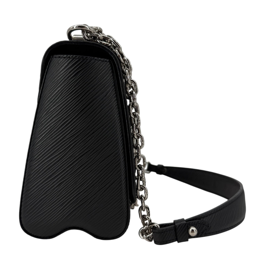 Side view of Louis Vuitton Epi Twist MM Black Noir crossbody bag with silver chain strap.