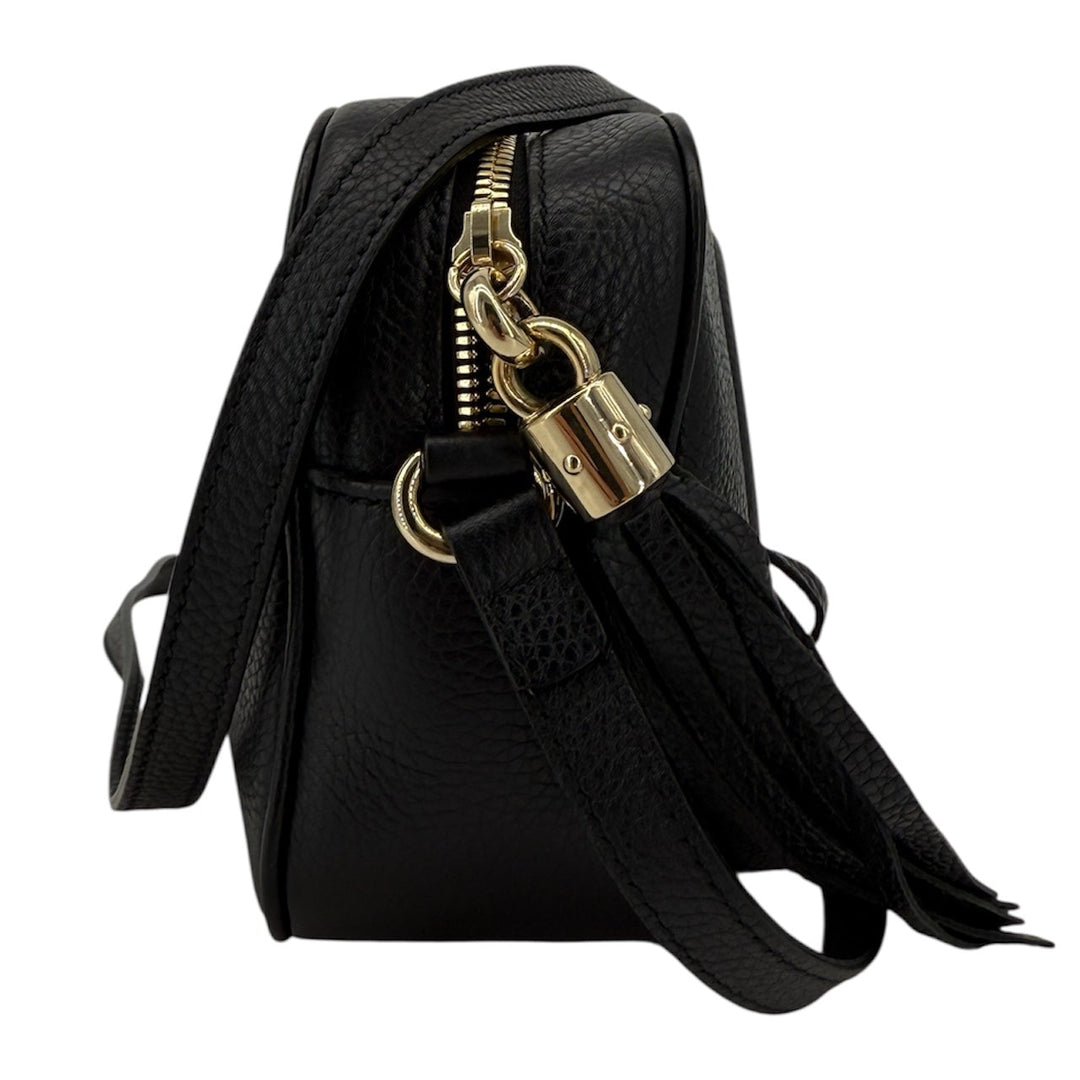 Gucci Soho Disco Small Crossbody in black pebbled calfskin showcasing tassel and gold hardware detail.