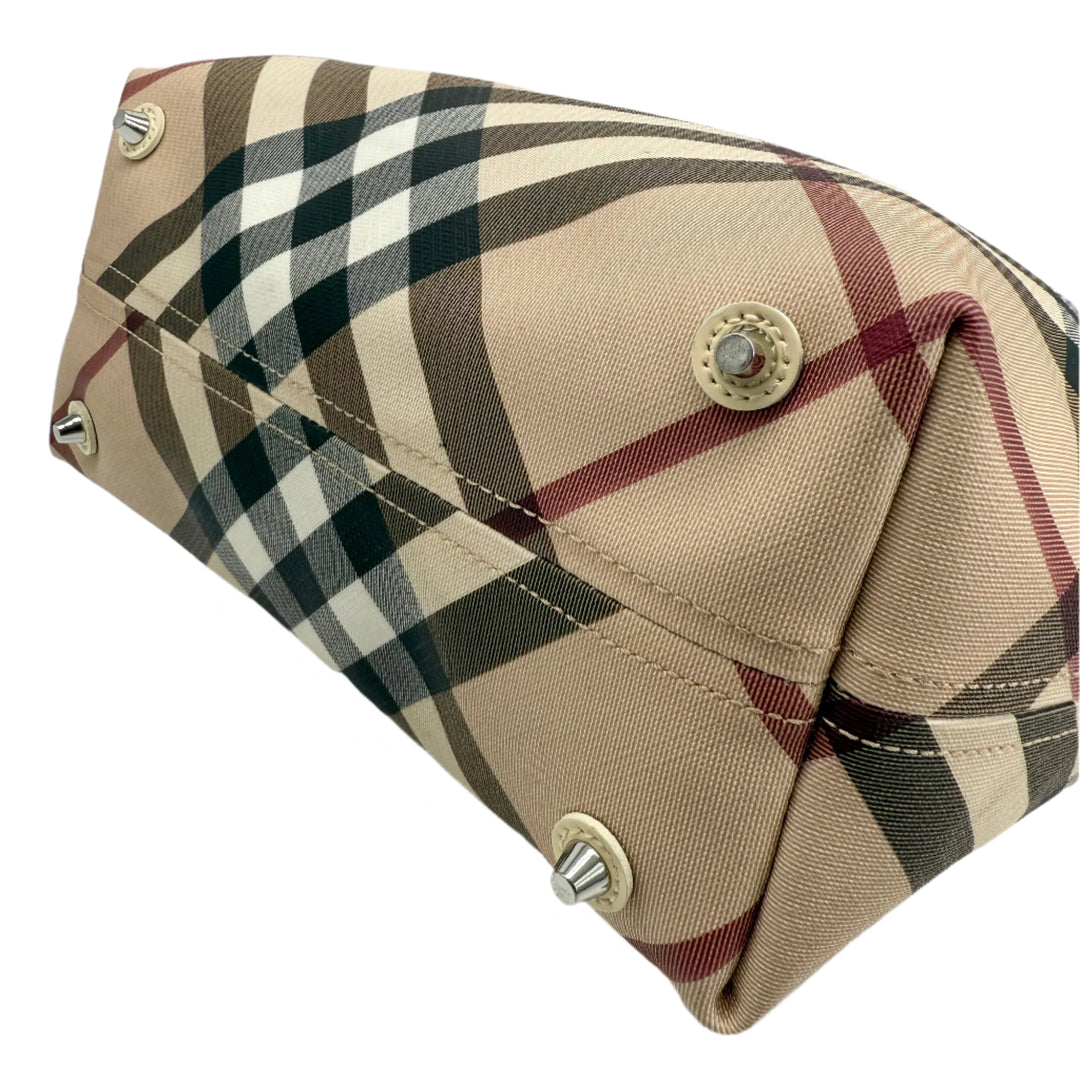 Burberry Nova Check Large Nickie Tote base showcasing classic check pattern and metallic studs for added style.