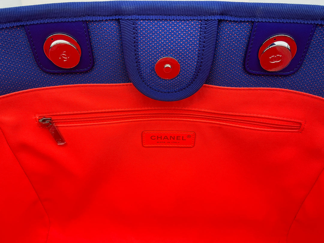 Interior view of Chanel Mixed Fibers Small Deauville Tote featuring a vibrant red lining and blue accents.