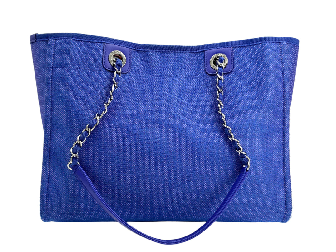 Chanel Mixed Fibers Small Deauville Tote in blue canvas with elegant leather handles and chain accents.