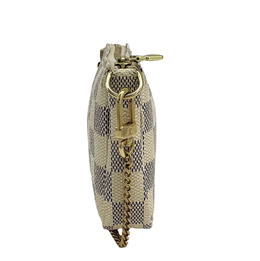 Side view of Louis Vuitton Damier Azur Mini Pochette Accessories wristlet pouch showcasing its elegant design and gold chain.