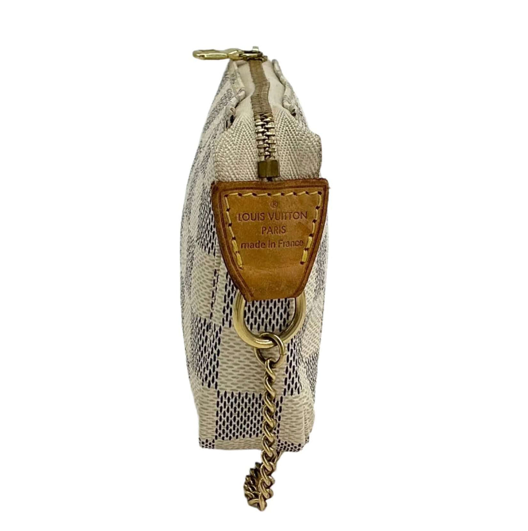 Side view of the Louis Vuitton Damier Azur Mini Pochette Accessories wristlet pouch with gold zipper and chain detailing.