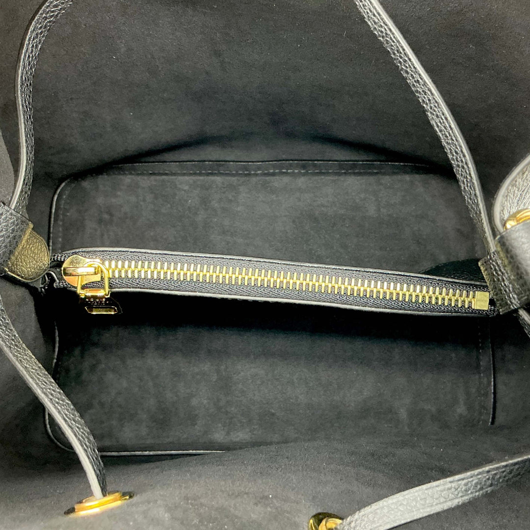 Interior view of the Louis Vuitton Empreinte Neonoe MM Bucket Bag featuring a zip pocket and soft black suede lining.