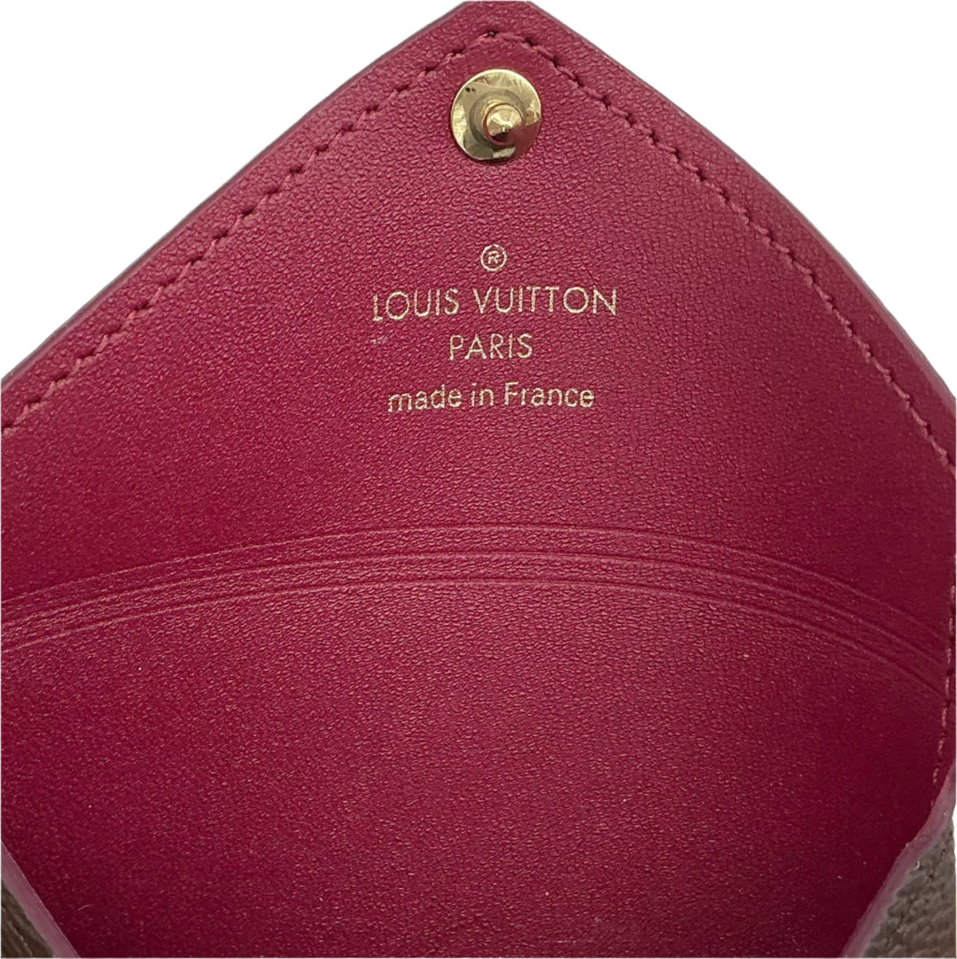 Interior view of Louis Vuitton Small Kirigami Pochette Insert featuring fuchsia leather and gold-tone branding.