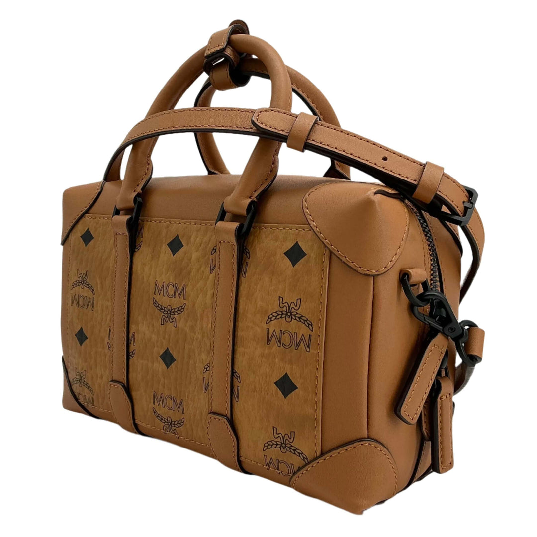 MCM handbag in tan leather showcasing MCM logo with distinctive diamond shapes, perfect for stylish everyday use.