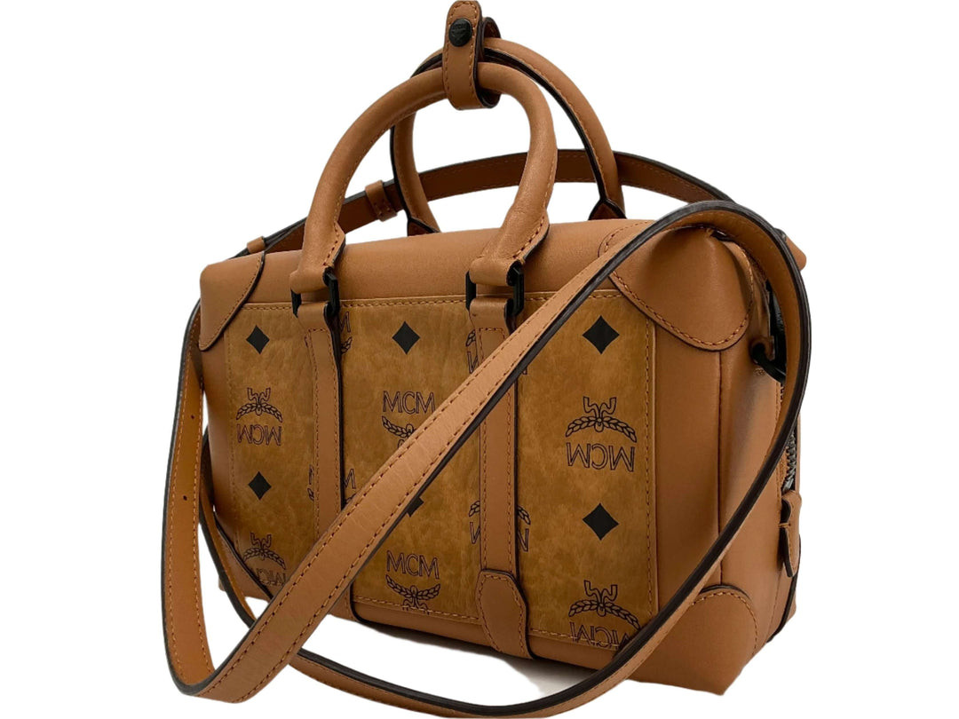 MCM brown leather handbag with signature logo design and detachable shoulder strap.