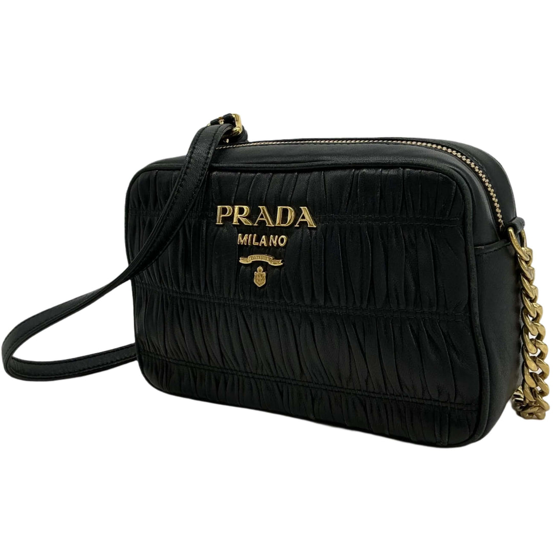 Prada Nappa Gaufre Camera Bag in black pleated lambskin leather with gold-tone branding and adjustable chain strap.