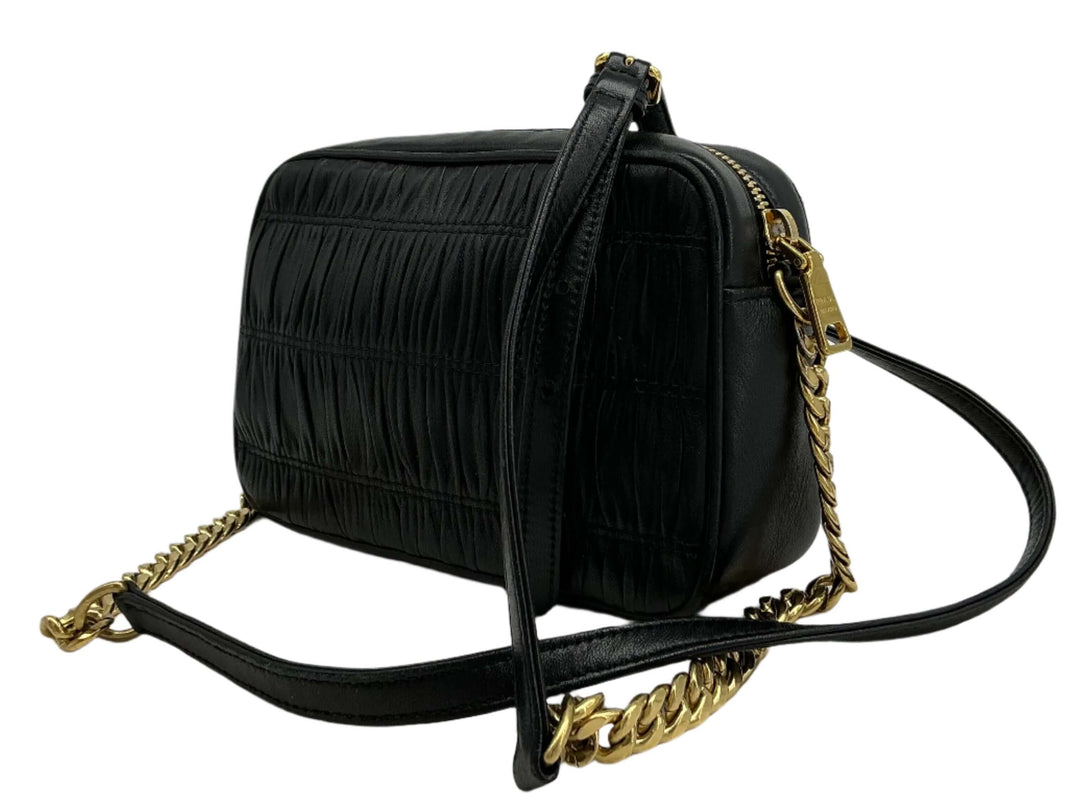 Prada Nappa Gaufre Camera Bag in black pleated lambskin leather with gold-tone chain strap, showcasing luxury and elegance.