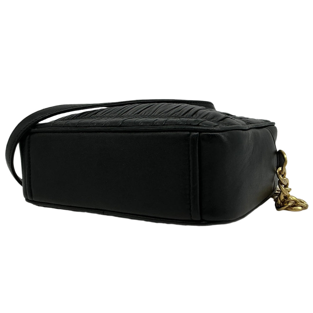 Prada Nappa Gaufre Camera Bag in black pleated lambskin leather, showing side view and gold-tone chain detail.