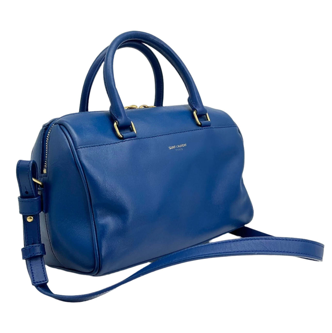 Saint Laurent Calfskin Classic Baby Duffle in blue leather, featuring rolled top handles and adjustable strap.
