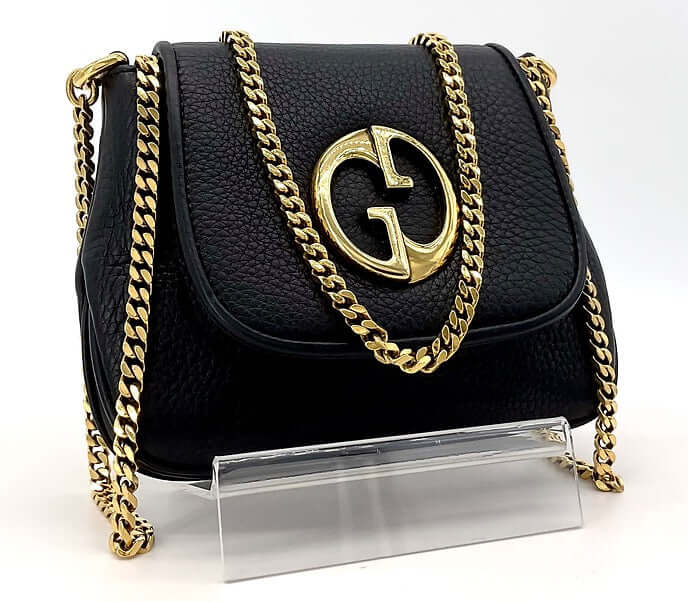 Authentic Gucci leather handbag in black with gold chain strap front view