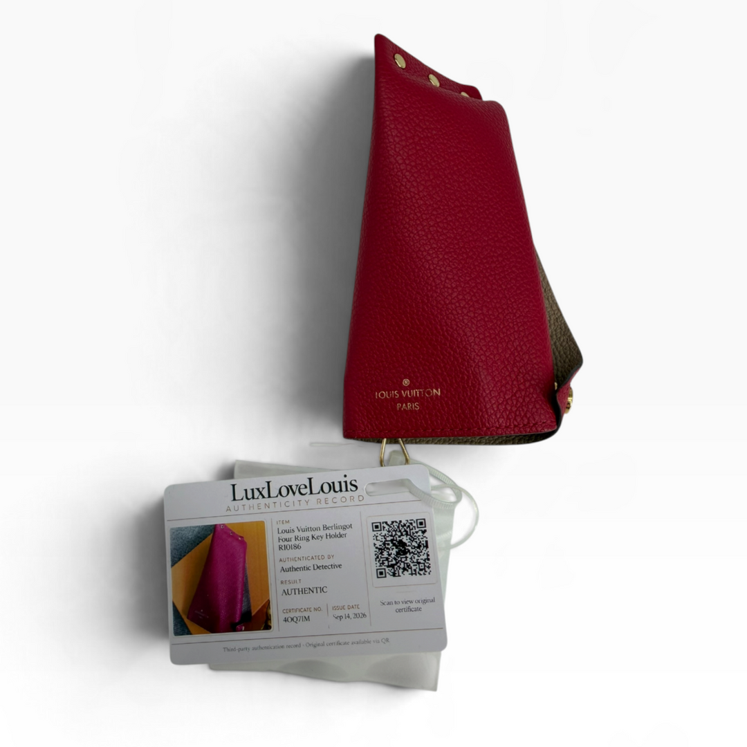 Louis Vuitton Multiclés Berlingot fuchsia pebbled leather key holder side with gold Louis Vuitton Paris logo and triangular shape