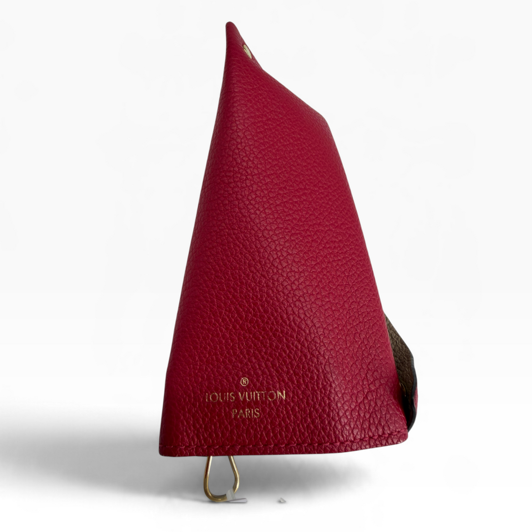 Louis Vuitton Multiclés Berlingot fuchsia leather key case angled profile showing triangular folded construction and gold-tone hardware