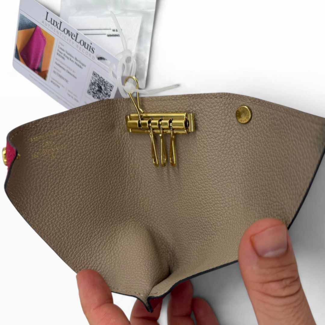 Louis Vuitton Multiclés Berlingot key holder open showing taupe grained leather interior, gold-tone key hardware and snap closure