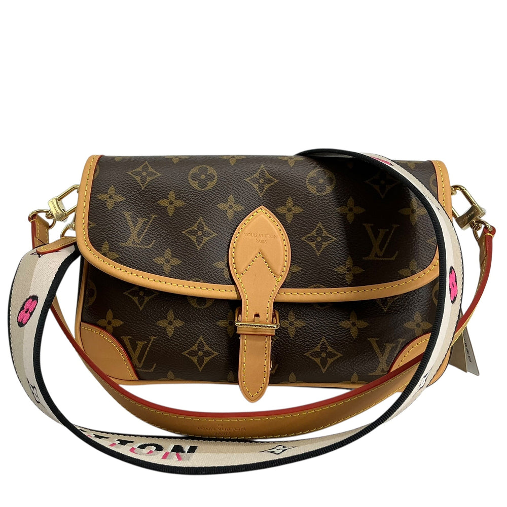 Louis Vuitton monogram canvas shoulder bag with tan leather trim and a white patterned shoulder strap, shown on a plain white background.