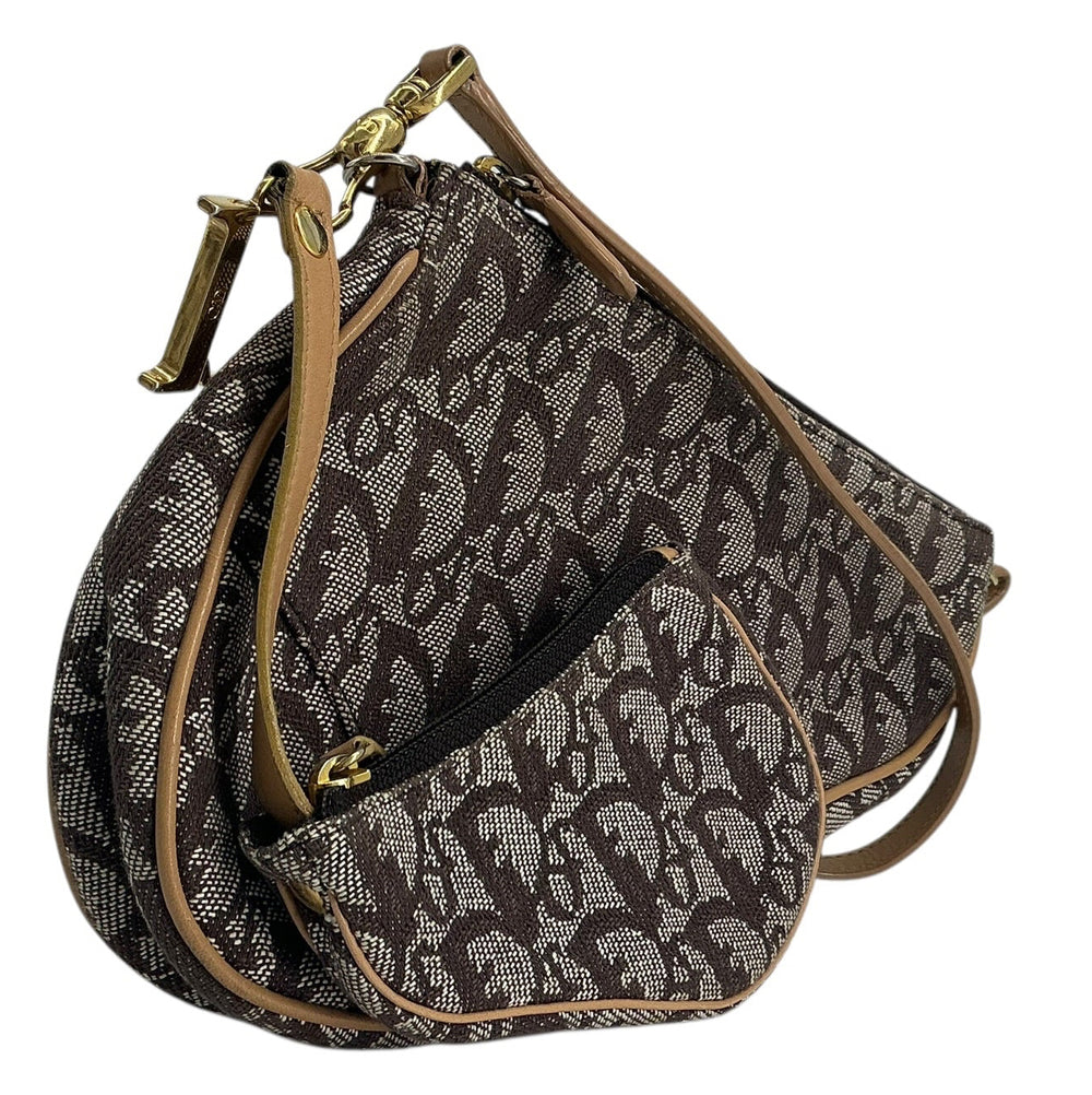 A dark brown and gray patterned handbag with tan leather trim and gold-tone hardware, shown on a plain white background.