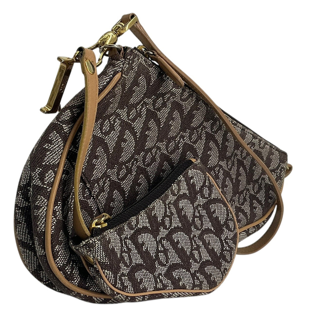 A dark brown and gray patterned handbag with tan leather trim and gold-tone hardware, shown on a plain white background.