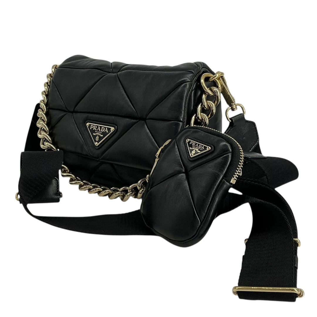 A black quilted Prada shoulder bag with gold-tone chain and strap hardware, shown on a plain white background.