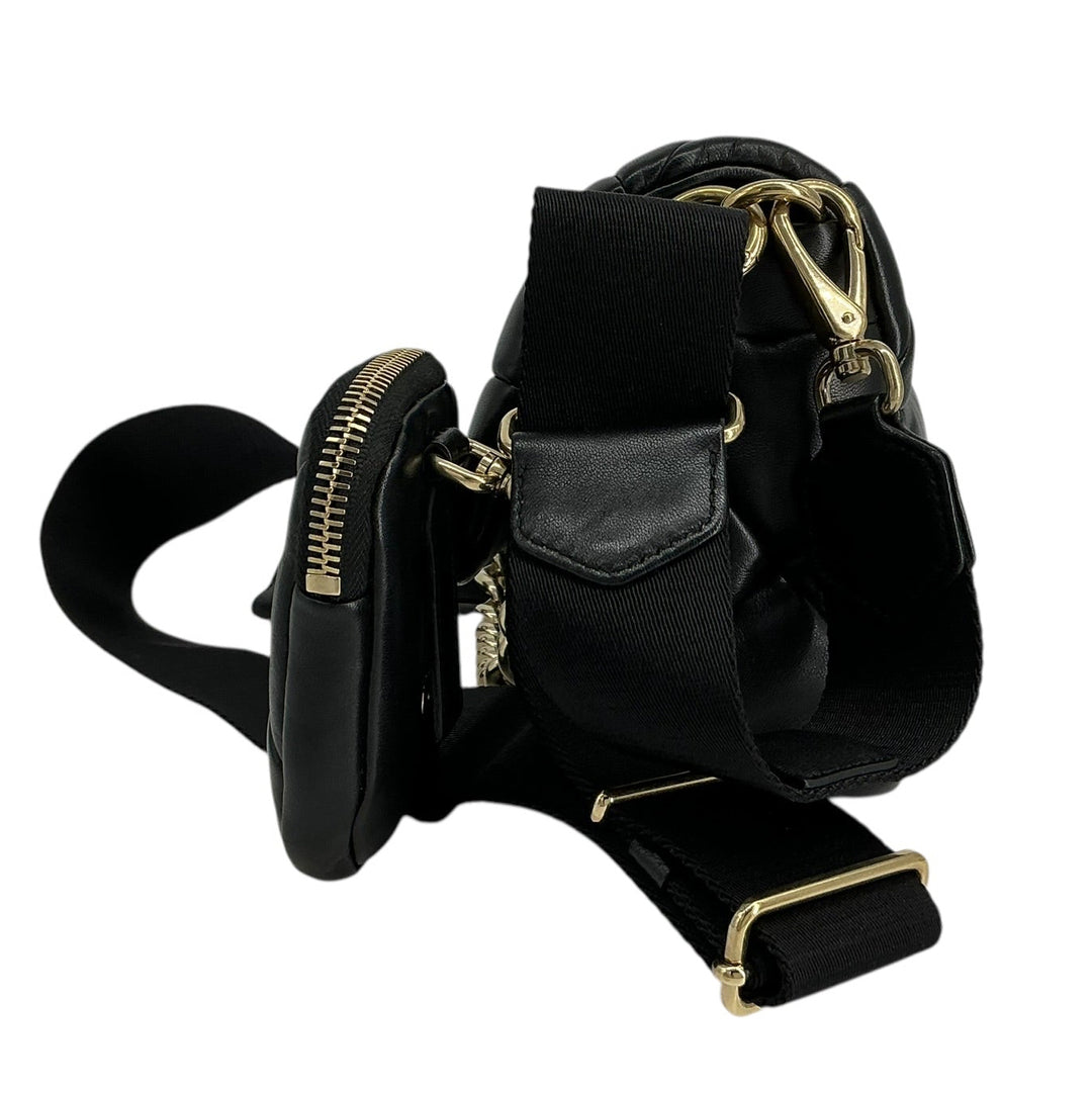 A black leather and nylon crossbody bag with gold-tone hardware, featuring a zippered pouch attachment and a wide adjustable strap, shown on a plain white background.