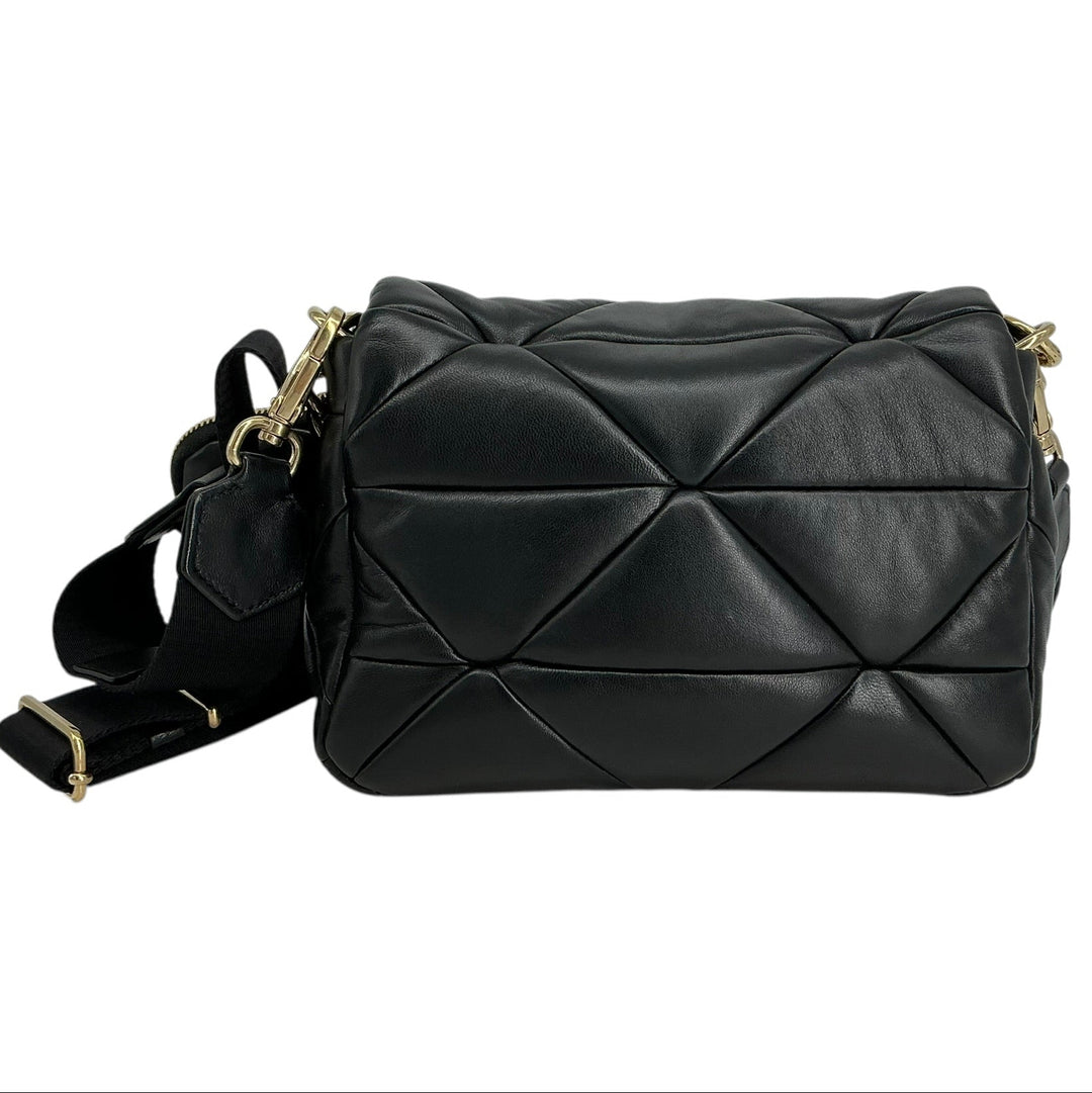 Black quilted leather shoulder bag with gold-tone hardware and a matching black fabric strap, shown on a plain white background.