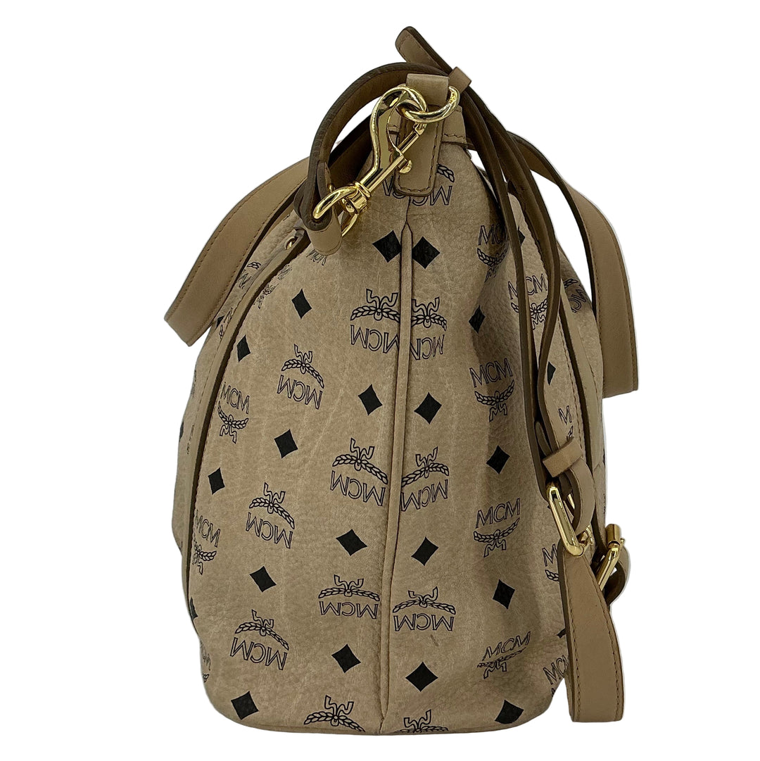 MCM Visetos Medium Essentials Shopper Tote in beige with black monogram pattern, showcasing refined leather trim and versatile design.