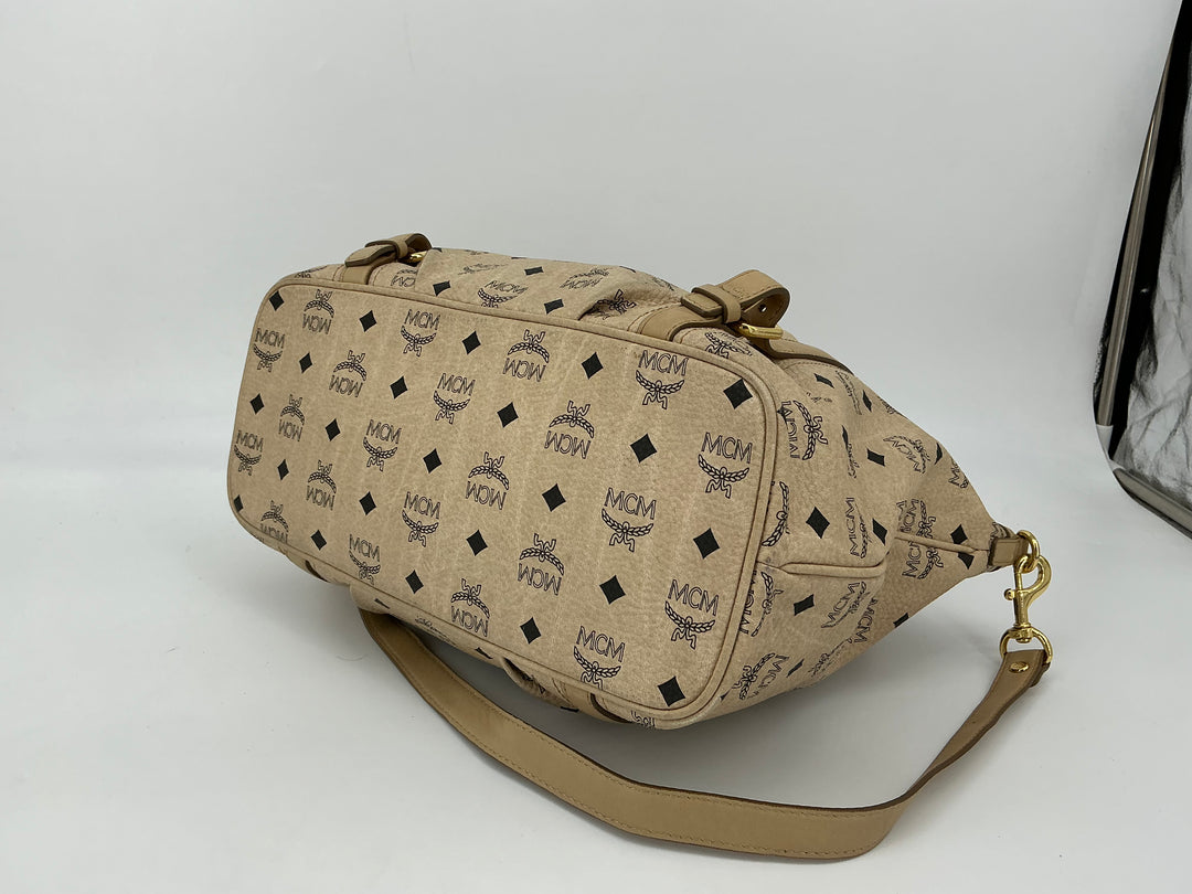 MCM Visetos Medium Essentials Shopper Tote in beige with black monogram, featuring refined leather trim and adjustable strap.