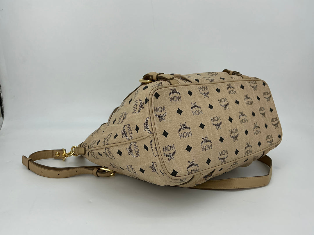 Beige MCM Visetos Medium Essentials Shopper Tote showcasing monogram pattern and leather trim.