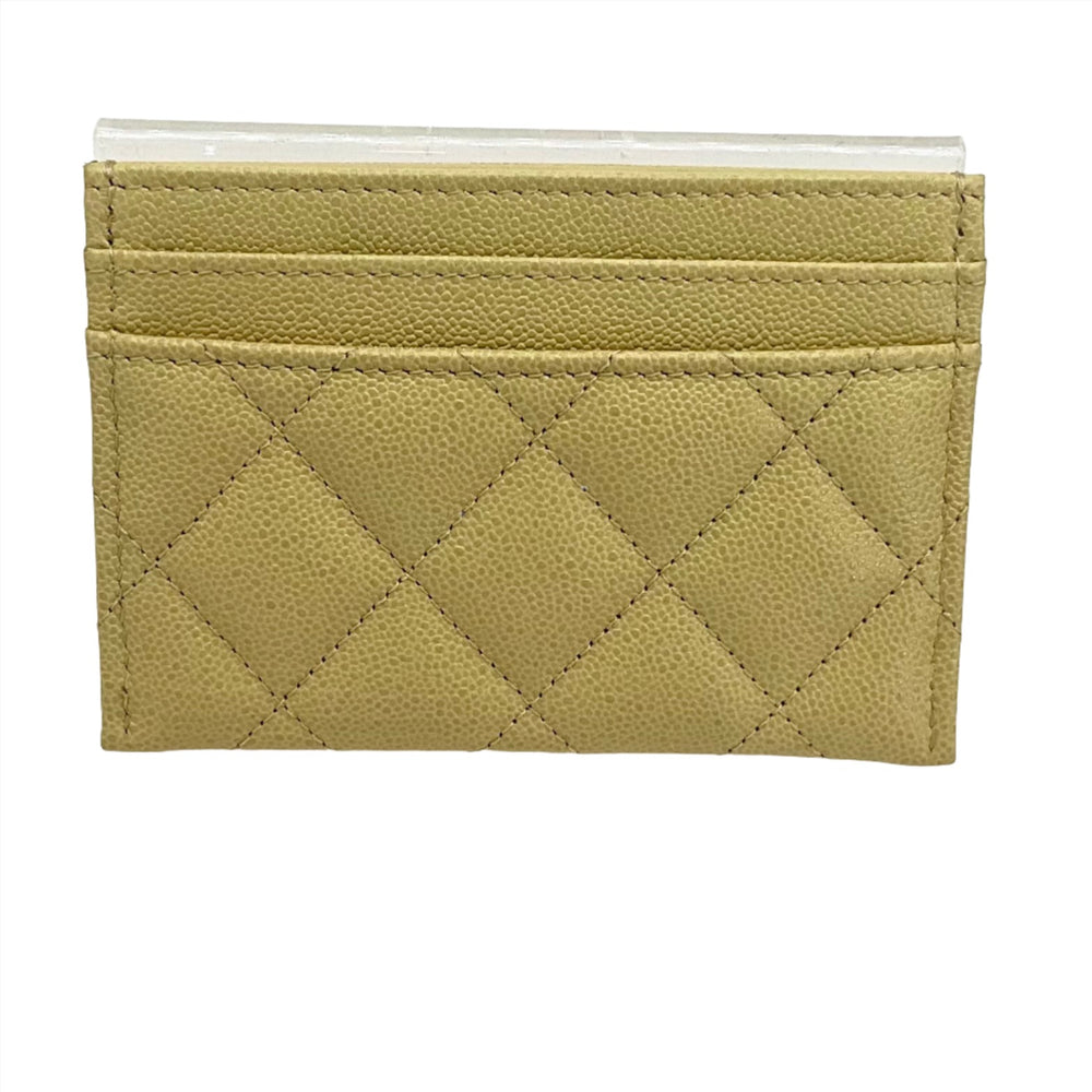 CHANEL Yellow Card Holder featuring quilted leather design and multiple card slots.