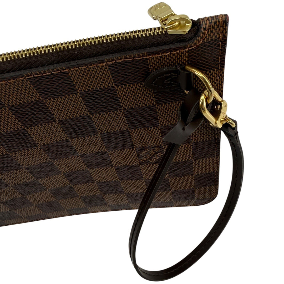 Louis Vuitton Damier Ebene wristlet strap and corner detail with gold-tone hardware